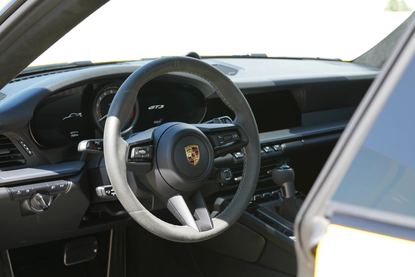 Yellow 2023 Porsche 911 GT3 parked in Marbella, available for rent from Prime Costa Rentals.