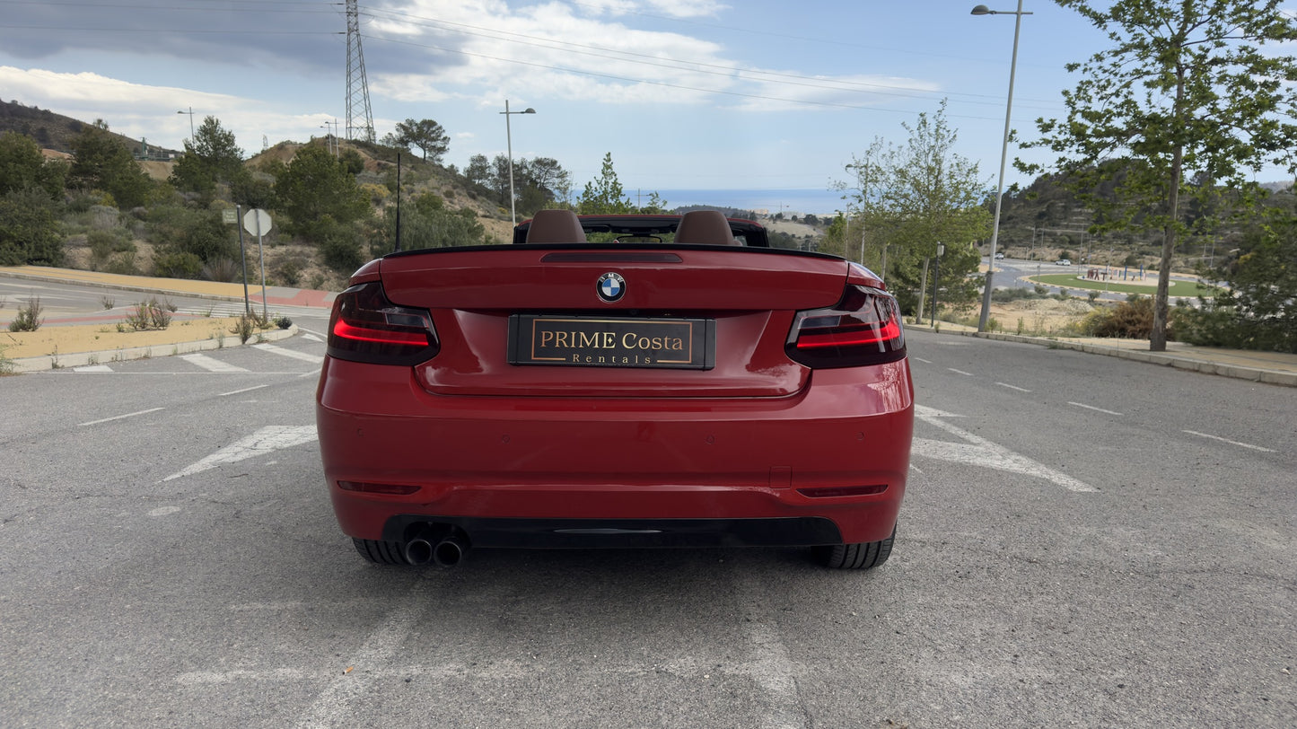 BMW 2 Series Cabrio parked in Benidorm, available for rent with delivery across Spain.