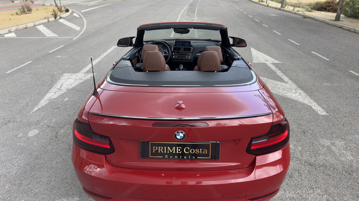 BMW 2 Series Cabrio parked in Benidorm, available for rent with delivery across Spain.