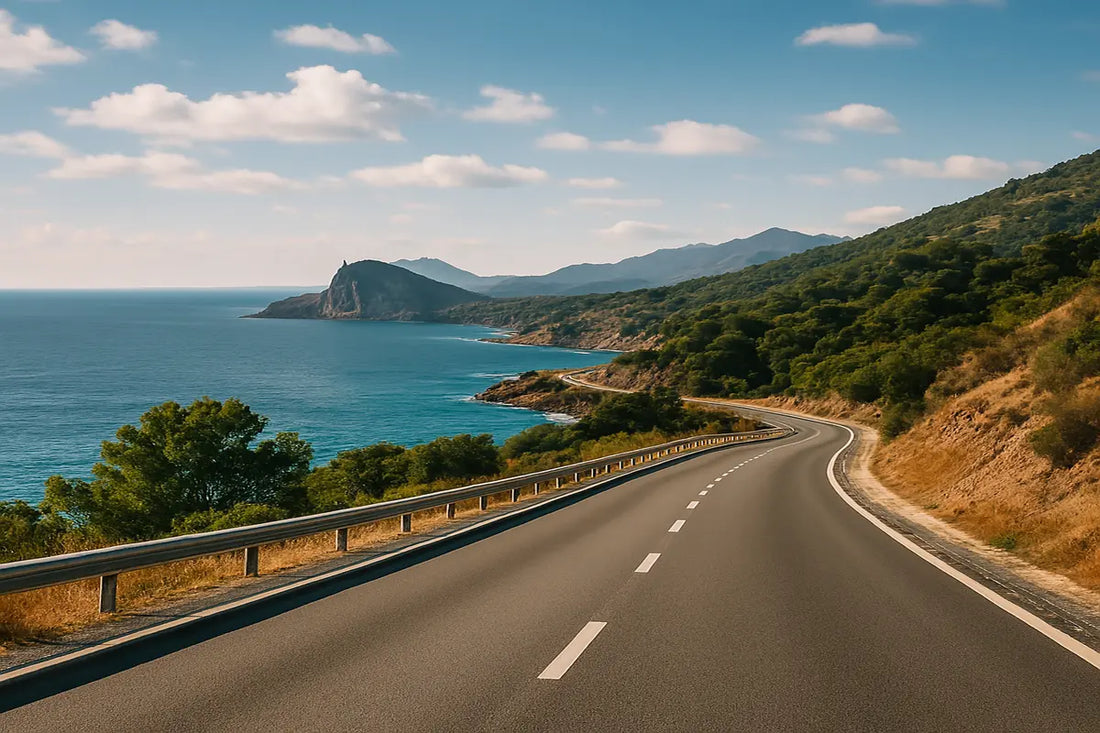 Scenic coastal road in Spain winding along the Mediterranean Sea, surrounded by green hills and cliffs — perfect for a road trip between Valencia and Marbella.