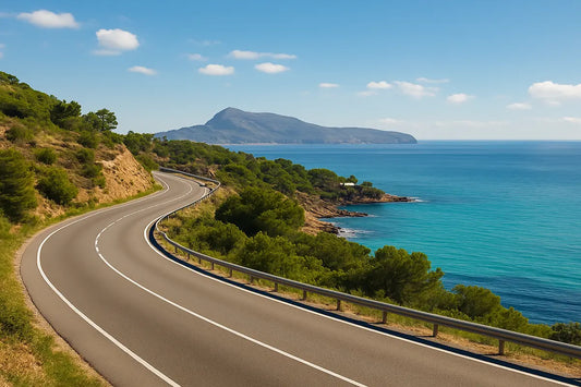 Scenic coastal road from Alicante to Altea with turquoise Mediterranean waters, green hills, and a mountain backdrop — perfect for a weekend road trip.