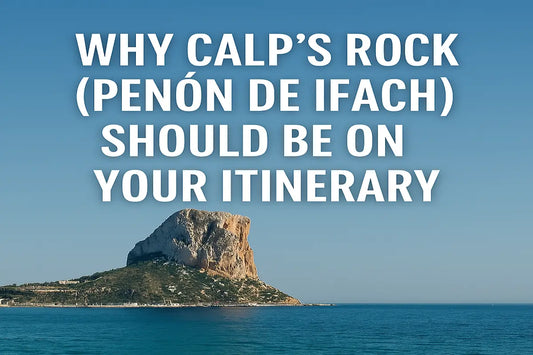 Massive limestone rock Peñón de Ifach rising from the sea in Calp, Spain, with clear blue skies and the Mediterranean coast in the background.