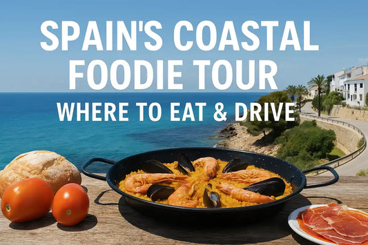 A table full of seafood tapas and paella on a Spanish coastal terrace, with sea views and wine glasses — perfect foodie stop on a road trip.