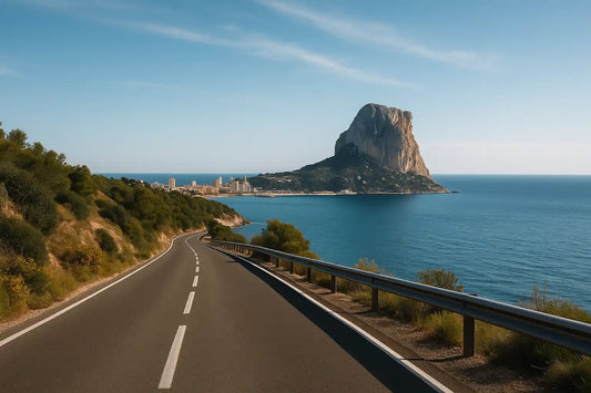 Scenic coastal road near Calp with views of the Peñón de Ifach rock and blue sea