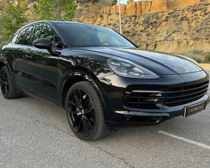 Black 2020 Porsche Cayenne front right side, pictured on empty street in Spain