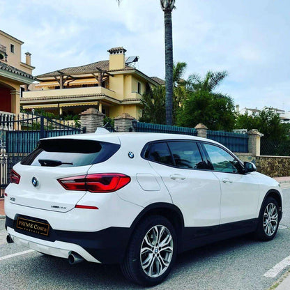 White BMW X2 SUV for rent in Marbella – automatic 4WD, 2.0L engine, compact 5-seater crossover.