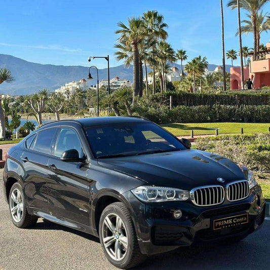 Black BMW X6 SUV for rent in Marbella – automatic, luxury 5-seater with a bold and sporty design.