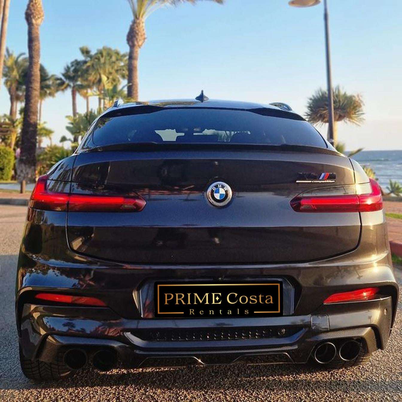Black BMW X4 M Competition SUV for rent in Marbella – luxury 5-seater with automatic transmission and sporty design.
