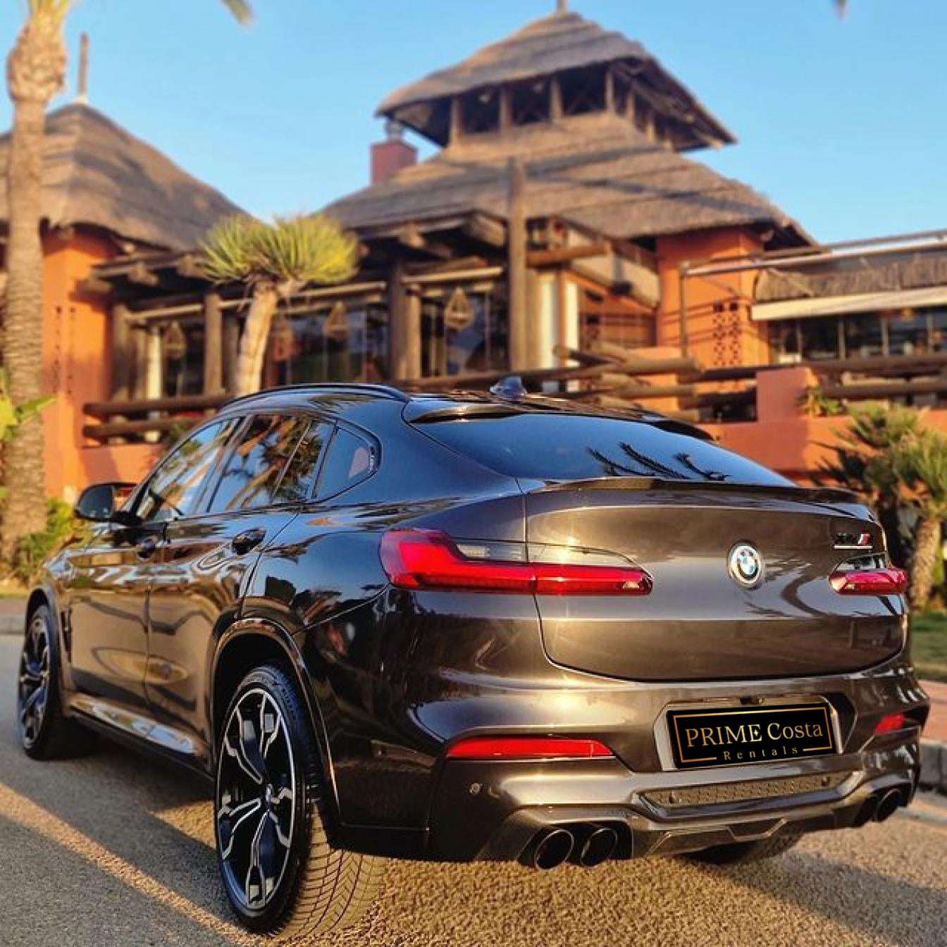 Black BMW X4 M Competition SUV for rent in Marbella – luxury 5-seater with automatic transmission and sporty design.
