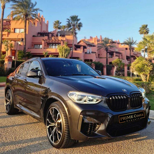 Black BMW X4 M Competition SUV for rent in Marbella – luxury 5-seater with automatic transmission and sporty design.

