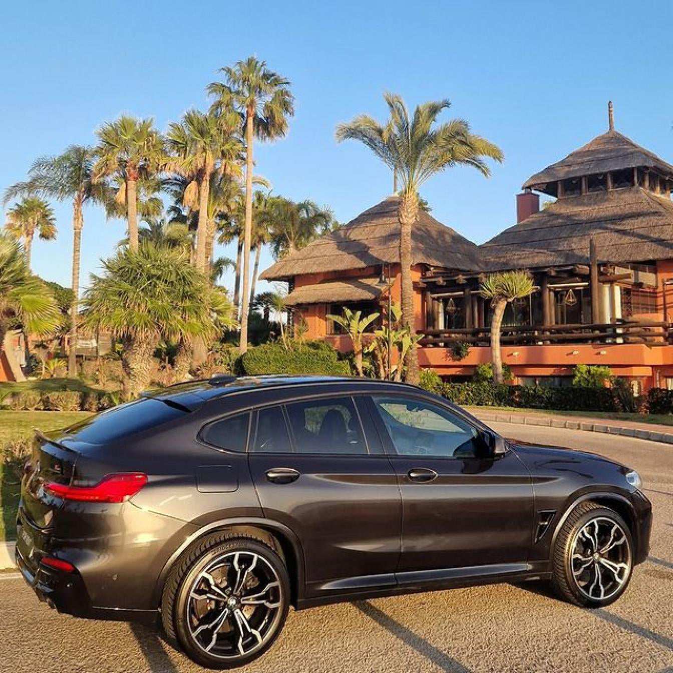 Black BMW X4 M Competition SUV for rent in Marbella – luxury 5-seater with automatic transmission and sporty design.
