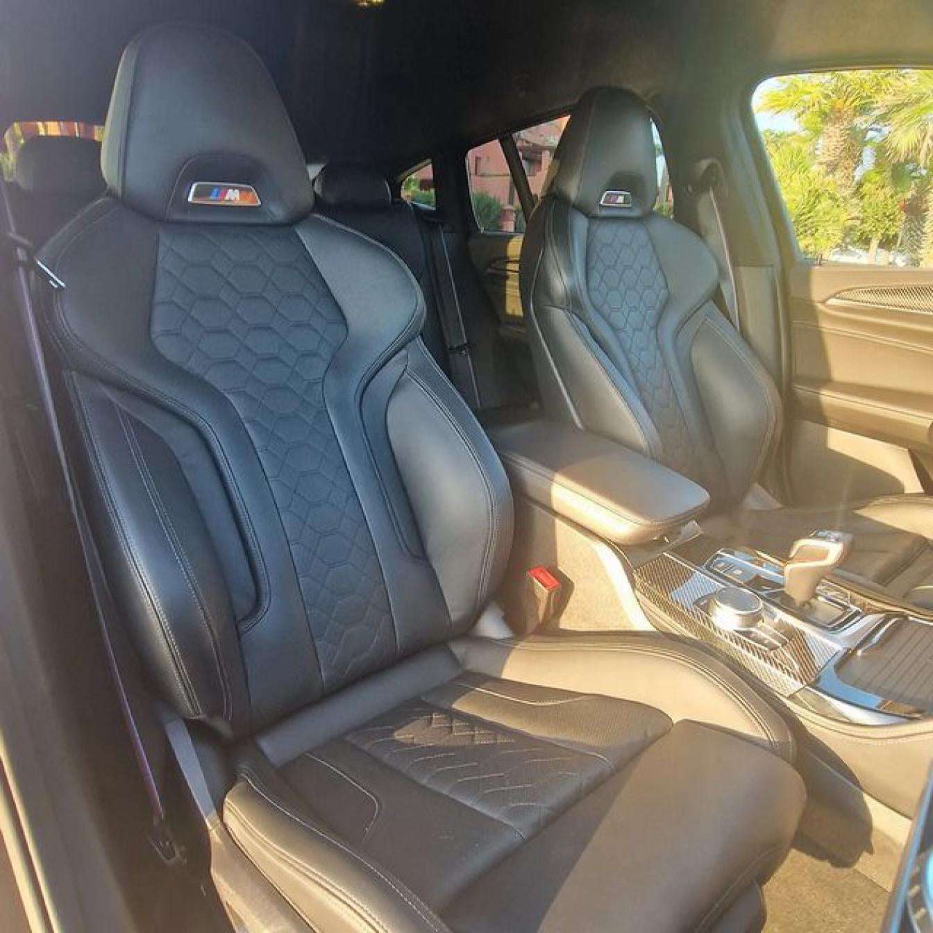 Black BMW X4 M Competition SUV for rent in Marbella – luxury 5-seater with automatic transmission and sporty design.
