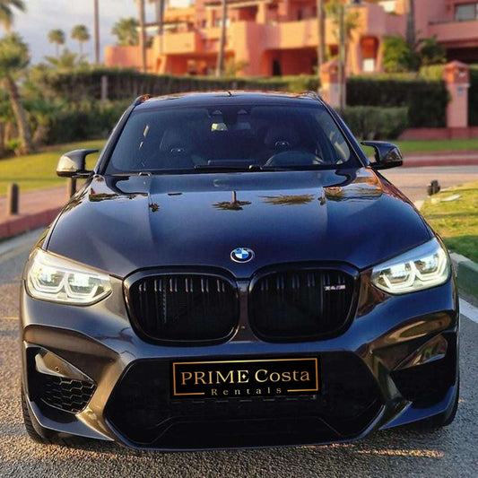 Black BMW X4 M Competition SUV for rent in Marbella – luxury 5-seater with automatic transmission and sporty design.
