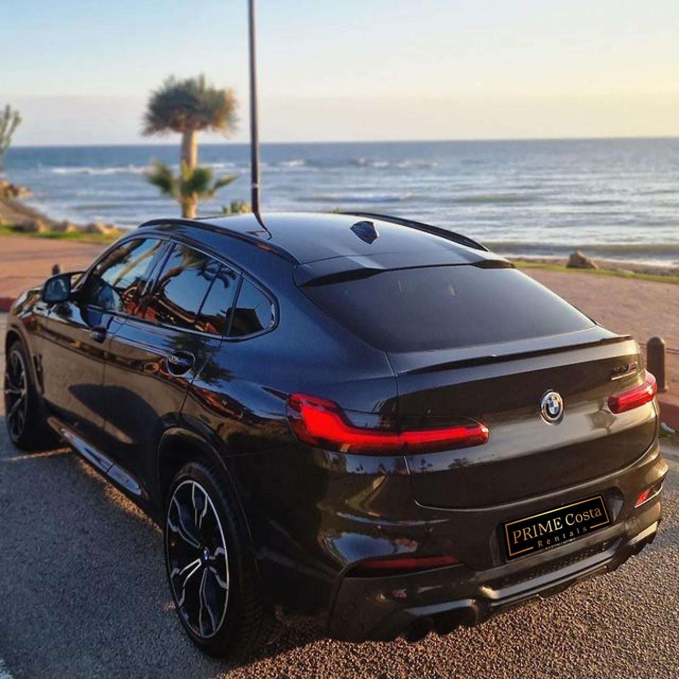 Black BMW X4 M Competition SUV for rent in Marbella – luxury 5-seater with automatic transmission and sporty design.
