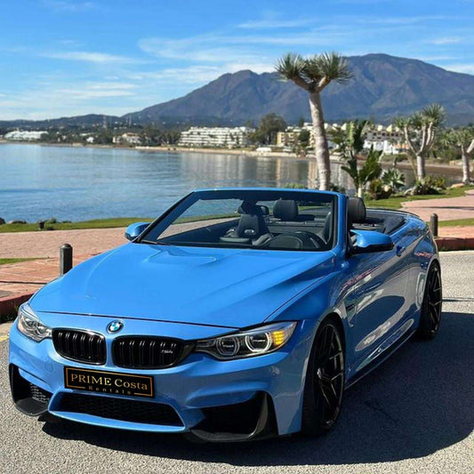 Blue BMW M4 Cabrio for rent in Marbella – automatic 4-seater convertible with sporty M styling.