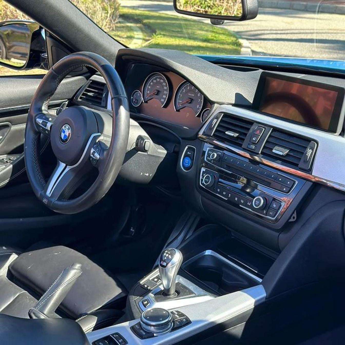 Blue BMW M4 Cabrio for rent in Marbella – automatic 4-seater convertible with sporty M styling.