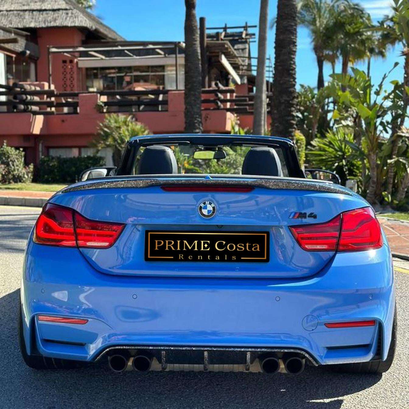 Blue BMW M4 Cabrio for rent in Marbella – automatic 4-seater convertible with sporty M styling.