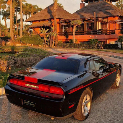 Black and red Dodge Challenger for rent in Marbella – automatic American muscle sedan.
