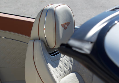 Front view of a white 2024 Bentley Continental GT Cabrio parked in Marbella, available for luxury rental.