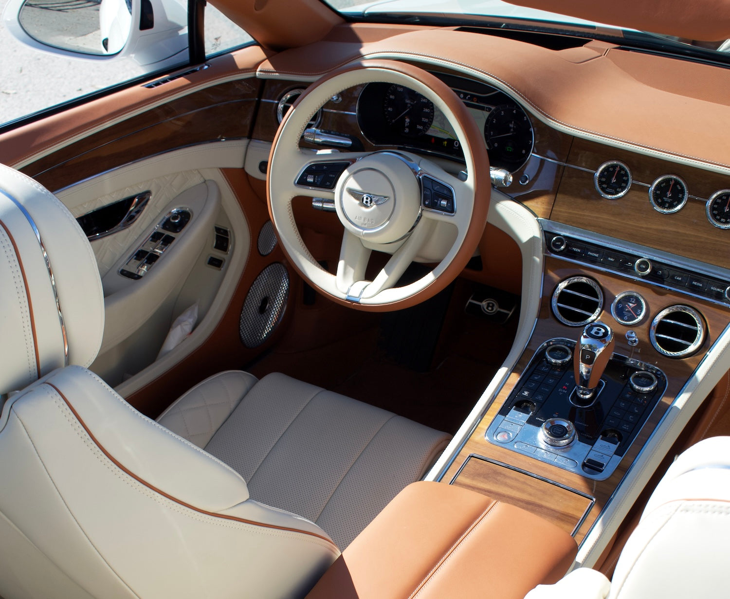 Front view of a white 2024 Bentley Continental GT Cabrio parked in Marbella, available for luxury rental.