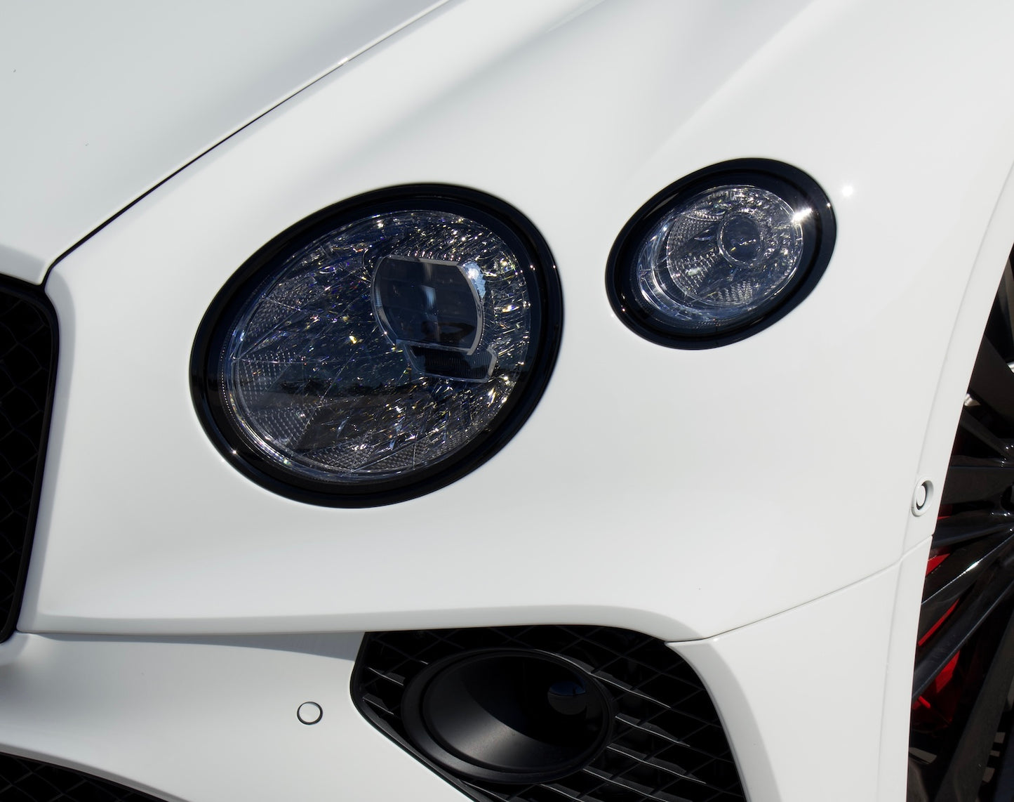 Front view of a white 2024 Bentley Continental GT Cabrio parked in Marbella, available for luxury rental.