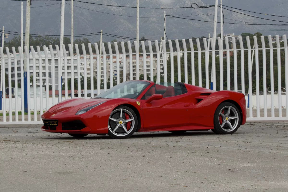 Red 2018 Ferrari 488 Spider convertible parked in Marbella, available for rent from Prime Costa Rentals.
