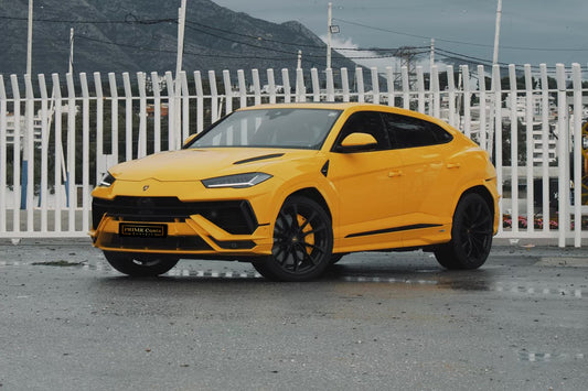 Yellow 2023 Lamborghini Urus S luxury SUV parked in Marbella, available for rent at Prime Costa Rentals.

