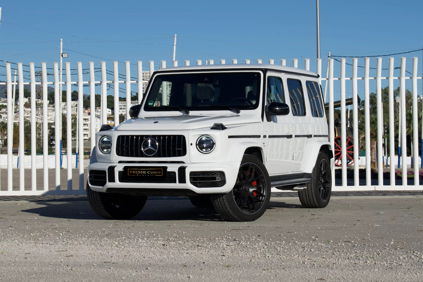 White 2023 Mercedes-AMG G 63 luxury SUV parked in Marbella, available for rent at Prime Costa Rentals.
