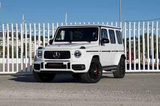 White 2023 Mercedes-AMG G 63 luxury SUV parked in Marbella, available for rent at Prime Costa Rentals.
