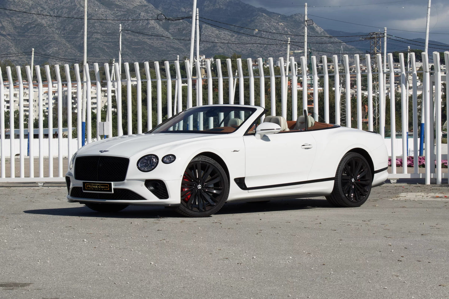 Front view of a white 2024 Bentley Continental GT Cabrio parked in Marbella, available for luxury rental.