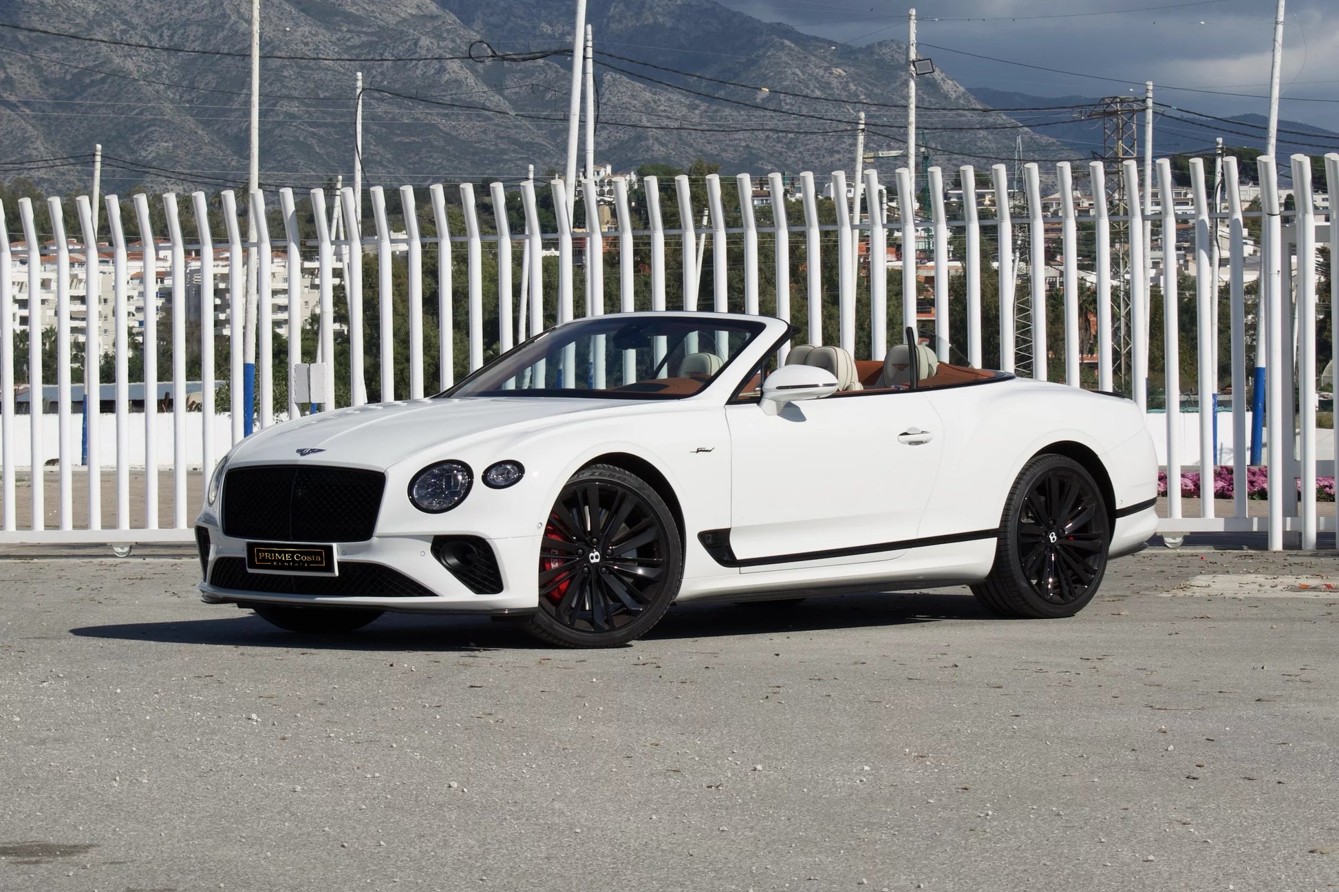 Front view of a white 2024 Bentley Continental GT Cabrio parked in Marbella, available for luxury rental.