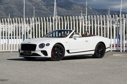 Front view of a white 2024 Bentley Continental GT Cabrio parked in Marbella, available for luxury rental.
