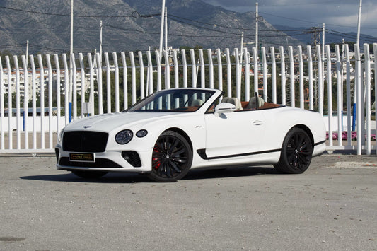 Front view of a white 2024 Bentley Continental GT Cabrio parked in Marbella, available for luxury rental.