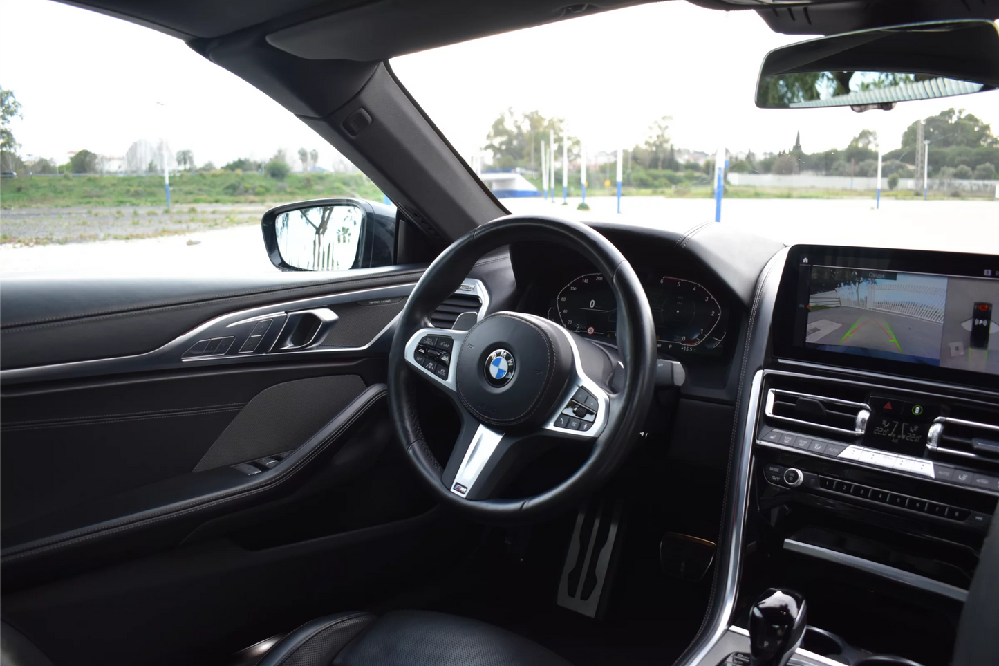 Black 2022 BMW 840d xDrive Cabrio convertible parked in Marbella, available for luxury rental.
