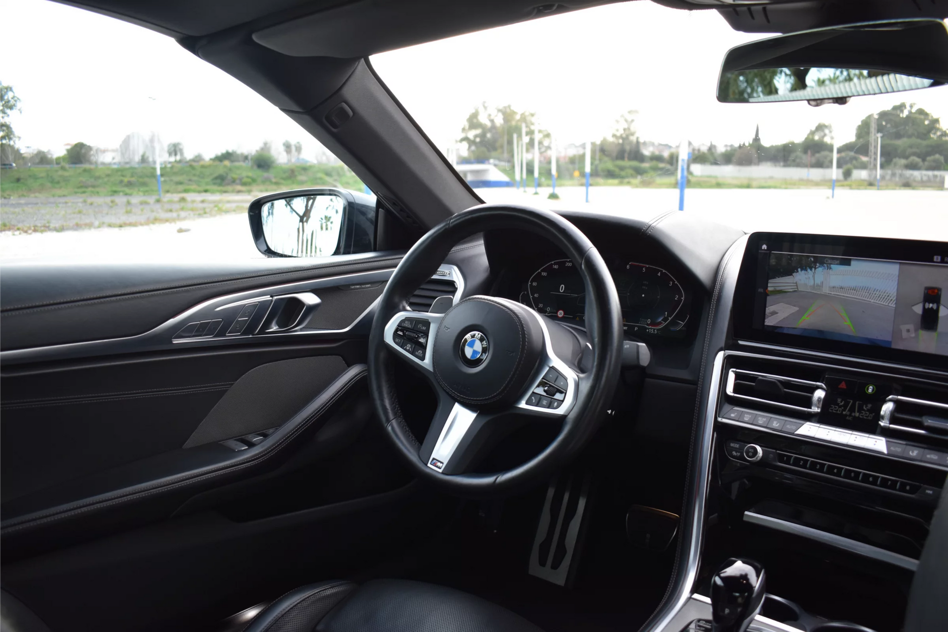 Black 2022 BMW 840d xDrive Cabrio convertible parked in Marbella, available for luxury rental.
