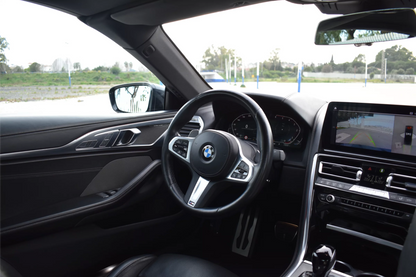 Black 2022 BMW 840d xDrive Cabrio convertible parked in Marbella, available for luxury rental.
