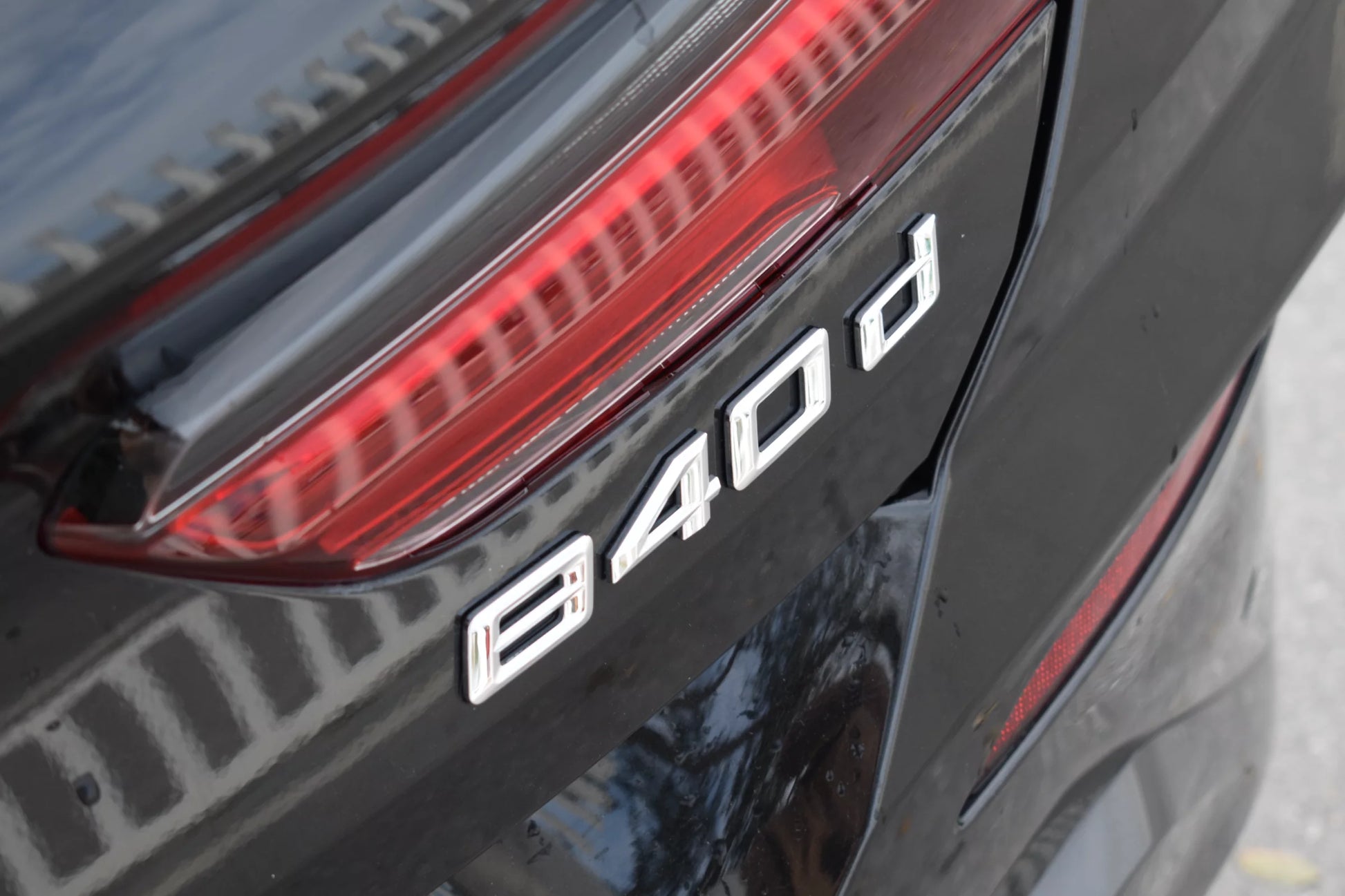 Black 2022 BMW 840d xDrive Cabrio convertible parked in Marbella, available for luxury rental.
