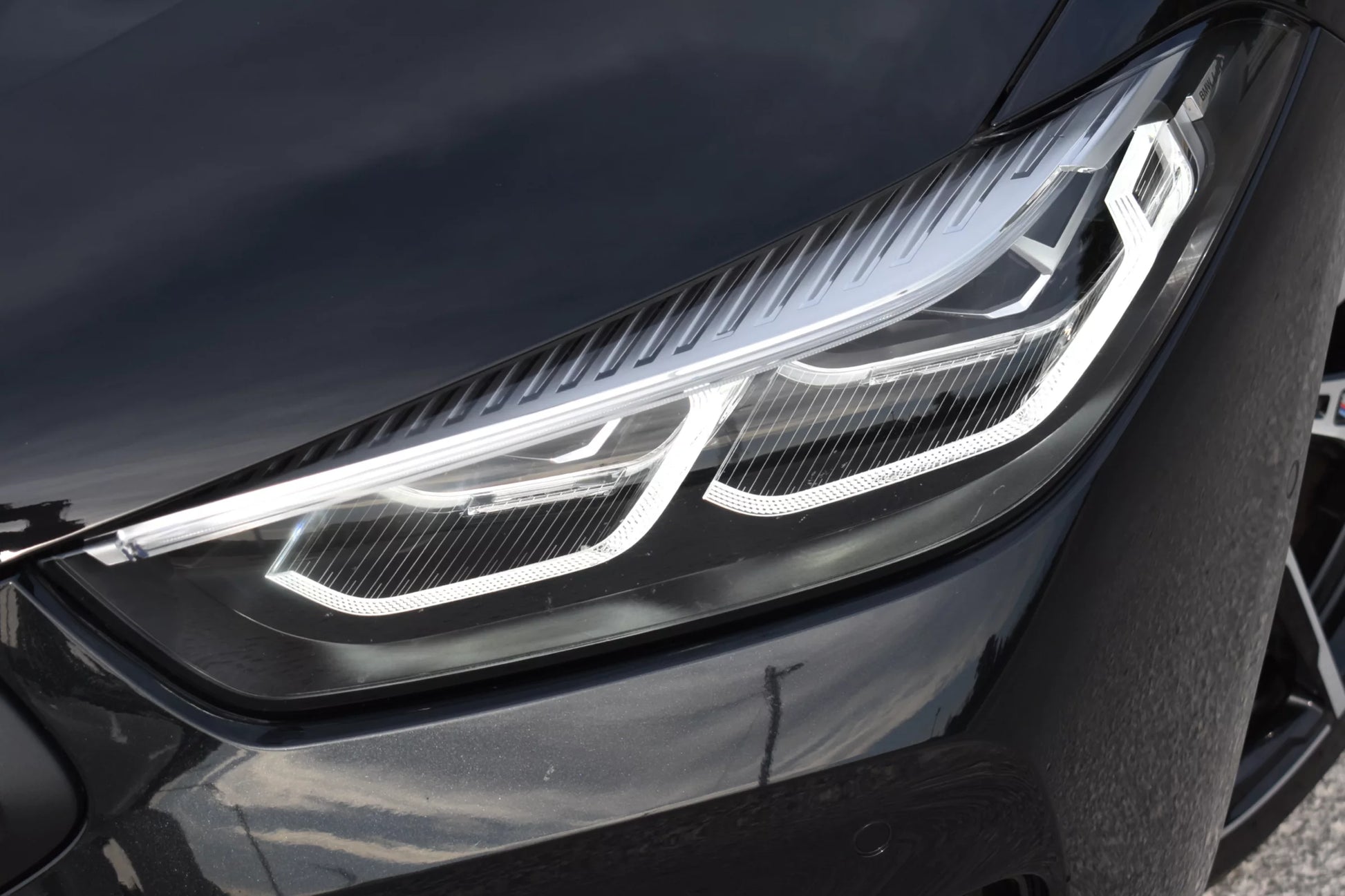 Black 2022 BMW 840d xDrive Cabrio convertible parked in Marbella, available for luxury rental.
