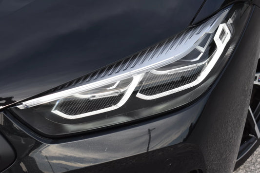 Black 2022 BMW 840d xDrive Cabrio convertible parked in Marbella, available for luxury rental.

