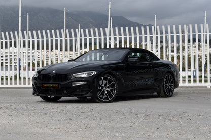 Black 2022 BMW 840d xDrive Cabrio convertible parked in Marbella, available for luxury rental.

