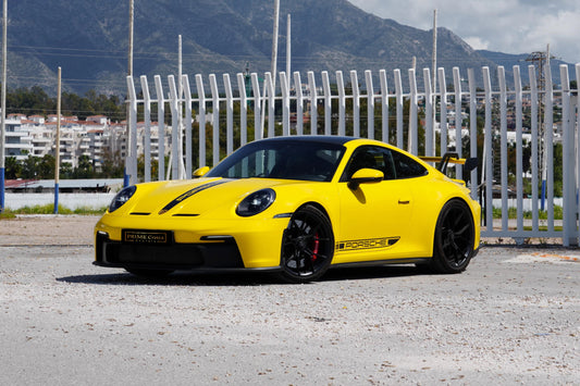 Yellow 2023 Porsche 911 GT3 parked in Marbella, available for rent from Prime Costa Rentals.
