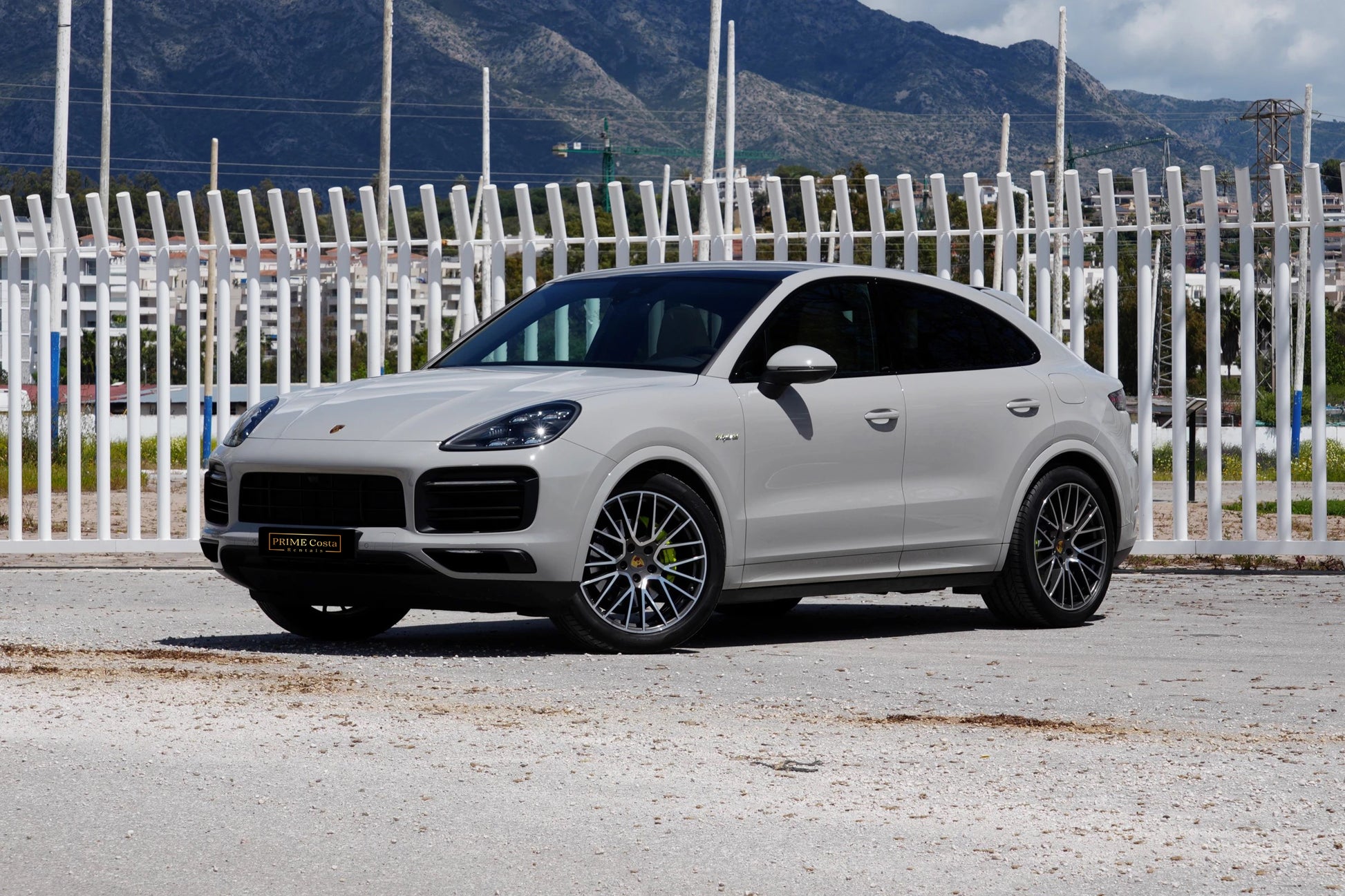 Grey 2023 Porsche Cayenne Coupe E-Hybrid SUV parked in Marbella, available for rent from Prime Costa Rentals.