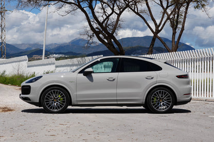 Grey 2023 Porsche Cayenne Coupe E-Hybrid SUV parked in Marbella, available for rent from Prime Costa Rentals.