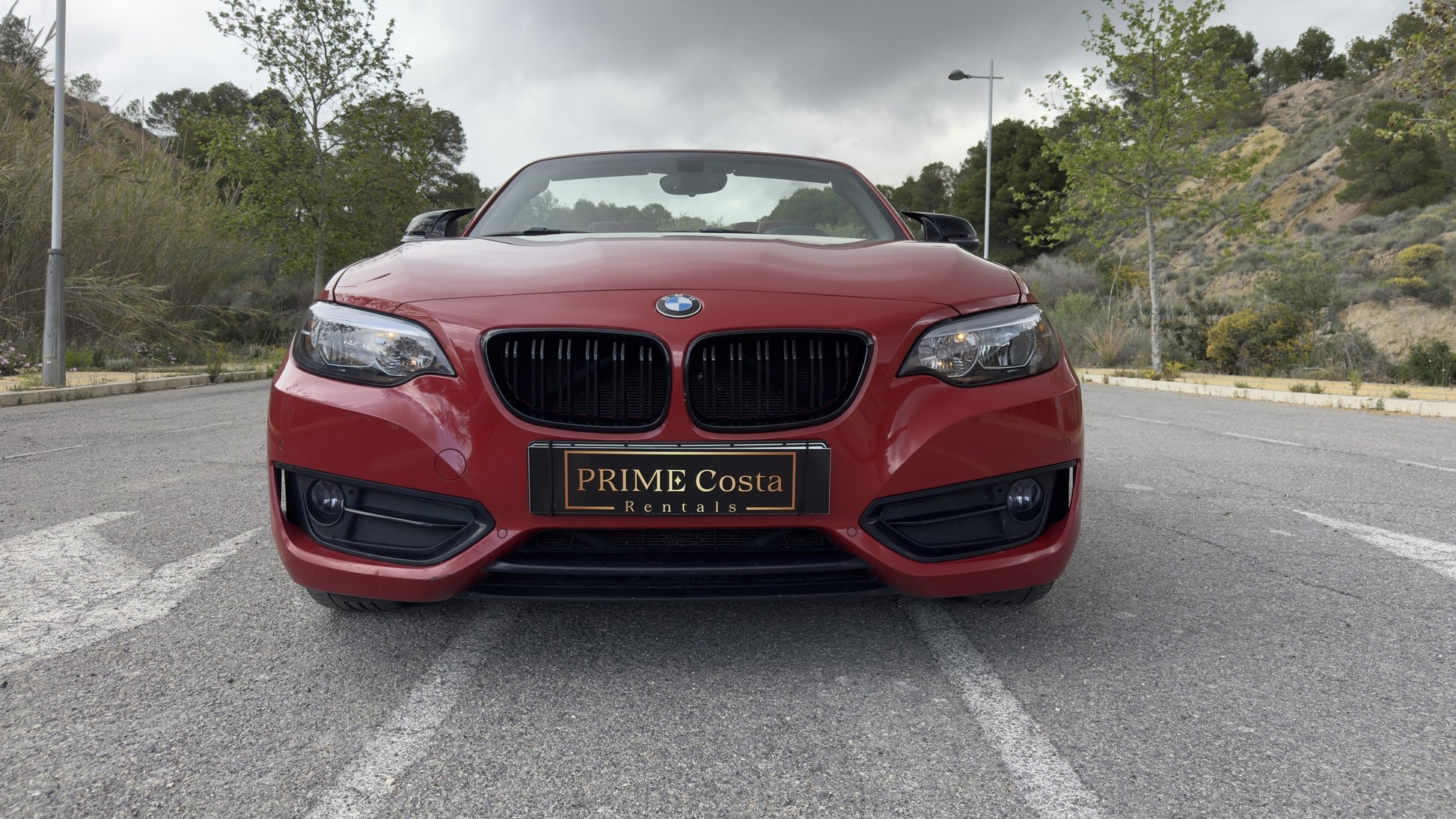 BMW 2 Series Cabrio parked in Benidorm, available for rent with delivery across Spain.
