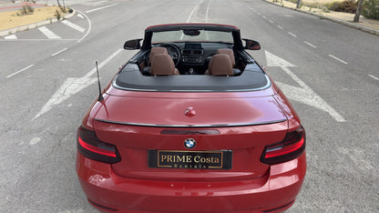 BMW 2 Series Cabrio parked in Benidorm, available for rent with delivery across Spain.
