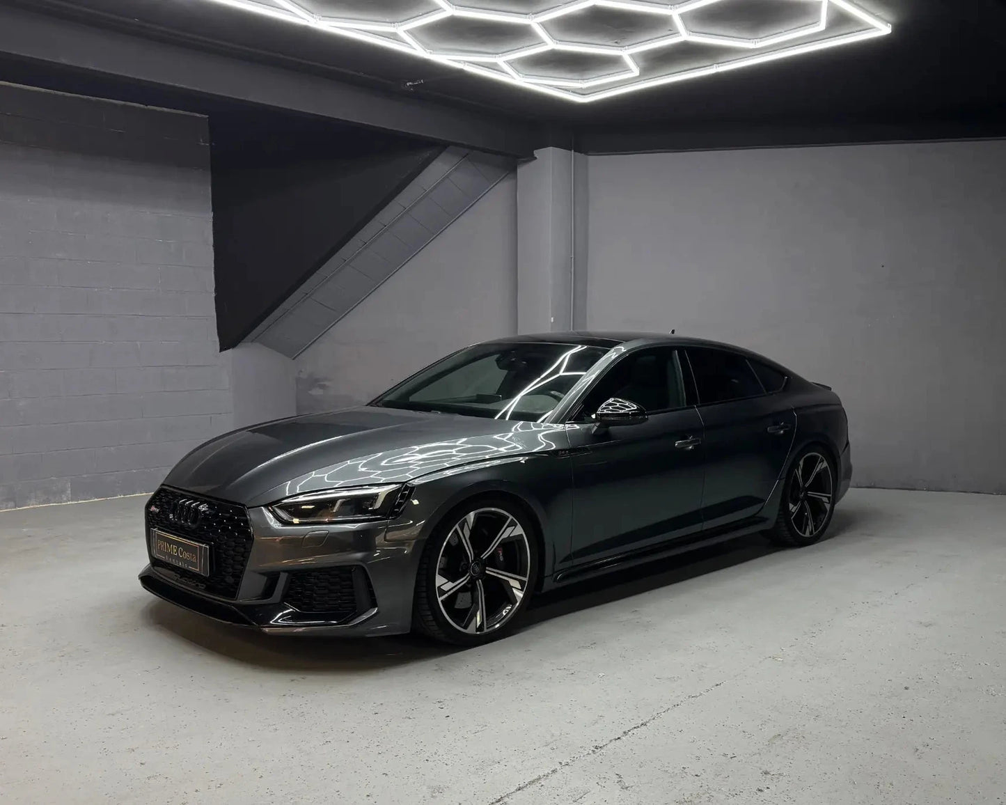 Audi RS5 Sportback in grey parked indoors available for luxury car hire in Alicante Costa Blanca