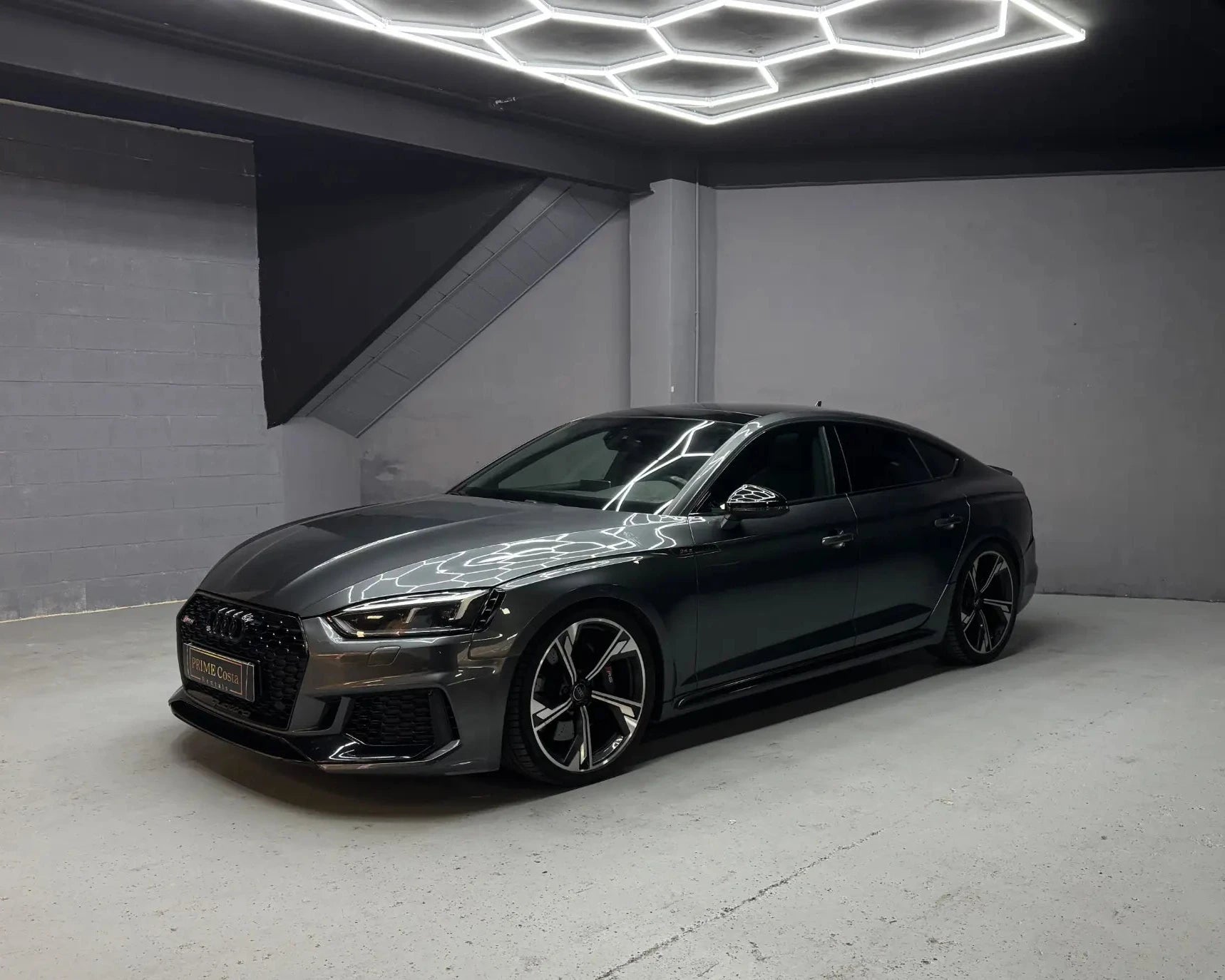 Audi RS5 Sportback in grey parked indoors available for luxury car hire in Alicante Costa Blanca