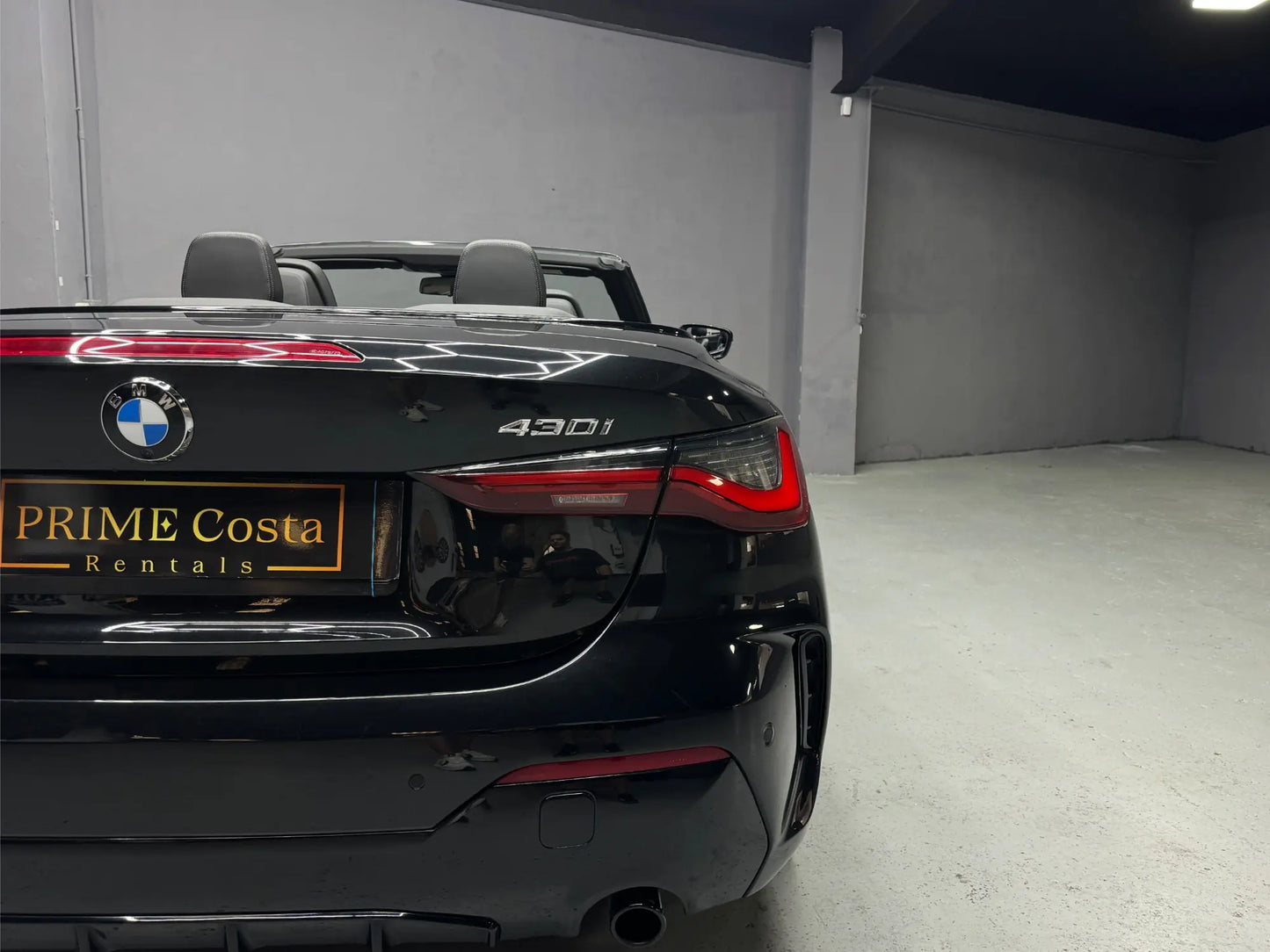 Close-up rear view of BMW 430i convertible with model badge visible