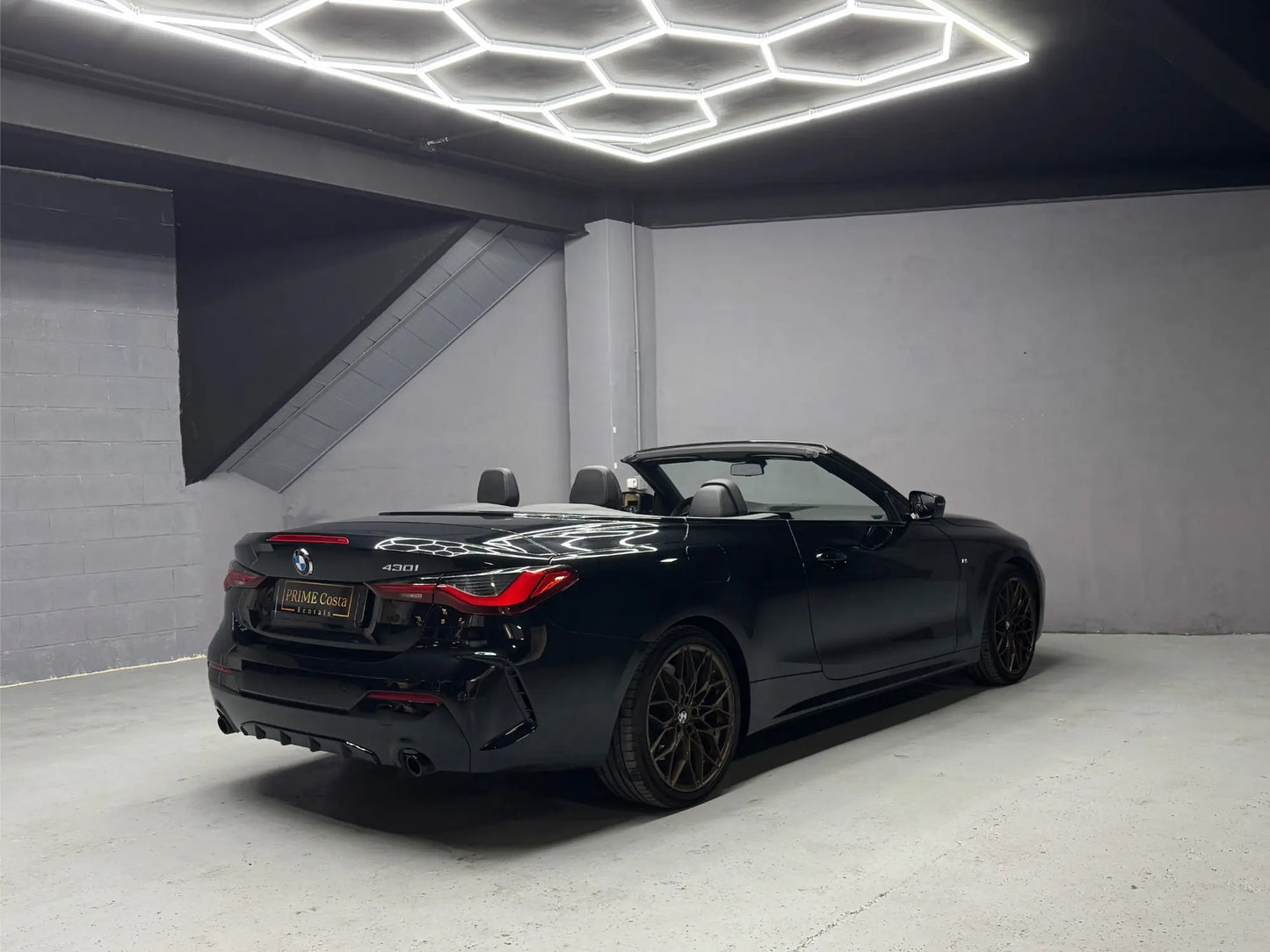Rear side view of BMW 430i convertible luxury rental car in Costa Blanca