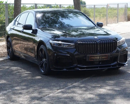 BMW 730D black front right side street view in parking with trees surrounded and blue sky